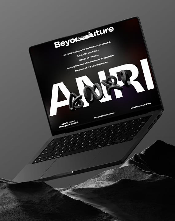 Laptop displaying "Beyond Future" website on rocks